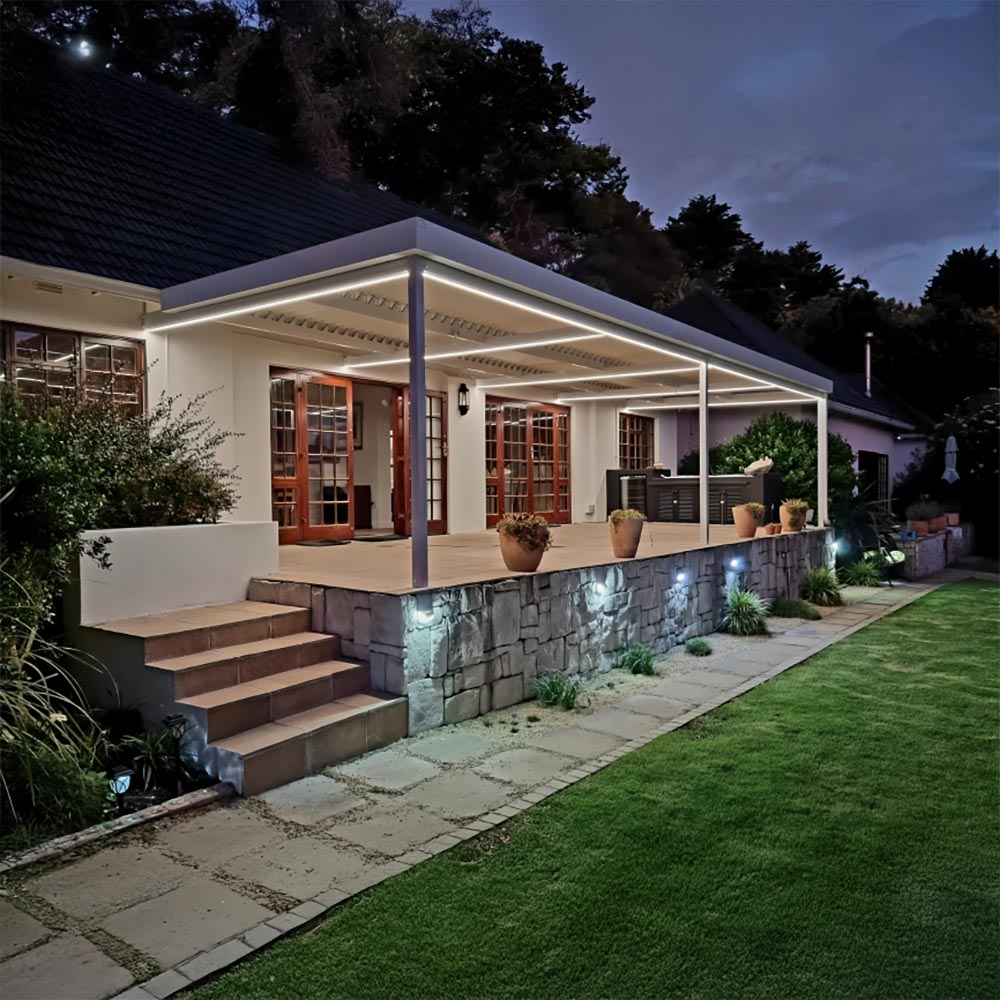 White louvred roof over a raised patio, lit by LED strips at dusk