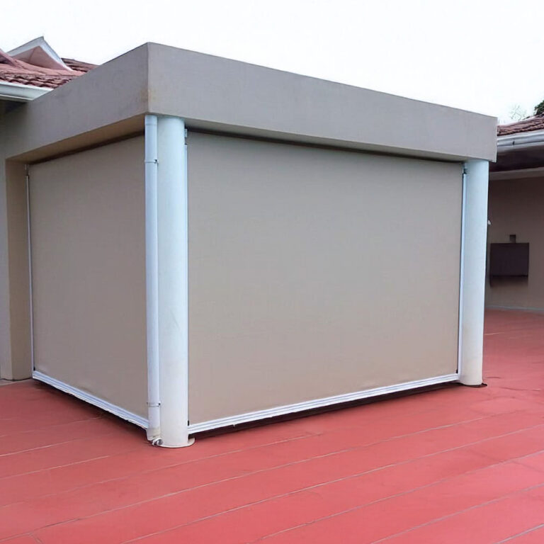 Beige side-track blinds wrapping the corner of a flat-roofed patio on a red deck